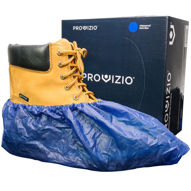 Waterproof shoe covers slipped over work boots next to a shoe cover box